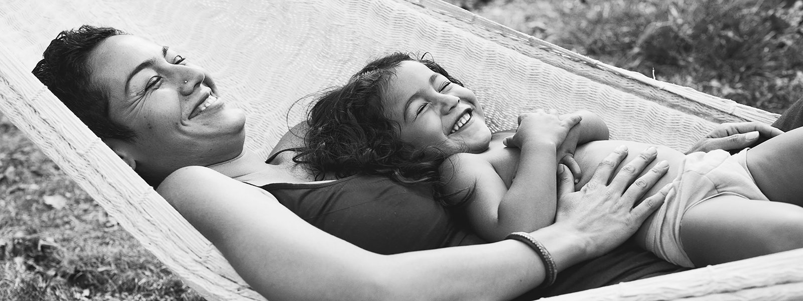 Amanda Reed Photography slideshow image of mother and daughter relaxing and laughing while in a hammock