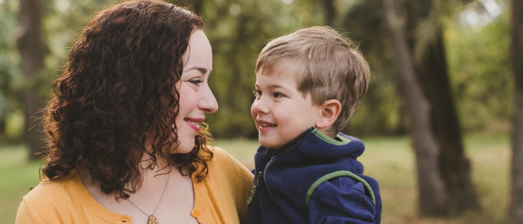 Mother and son smiling outdoors