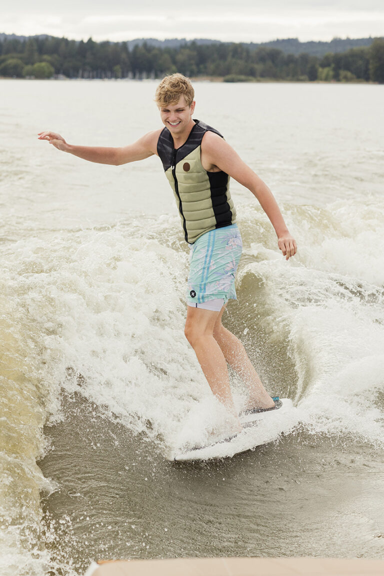 A man skillfully rides a wave on his board, showcasing his surfing talent and enjoying the water.