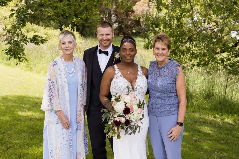 Wedding couple with family in garden setting