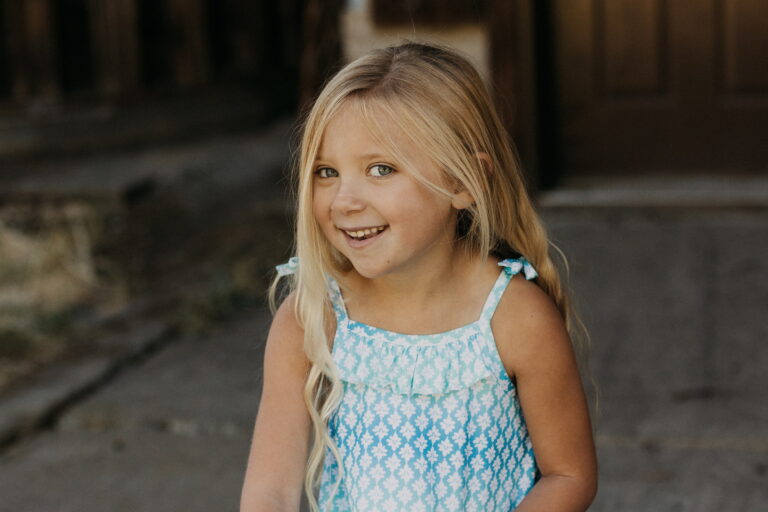 Smiling child outdoors in blue dress