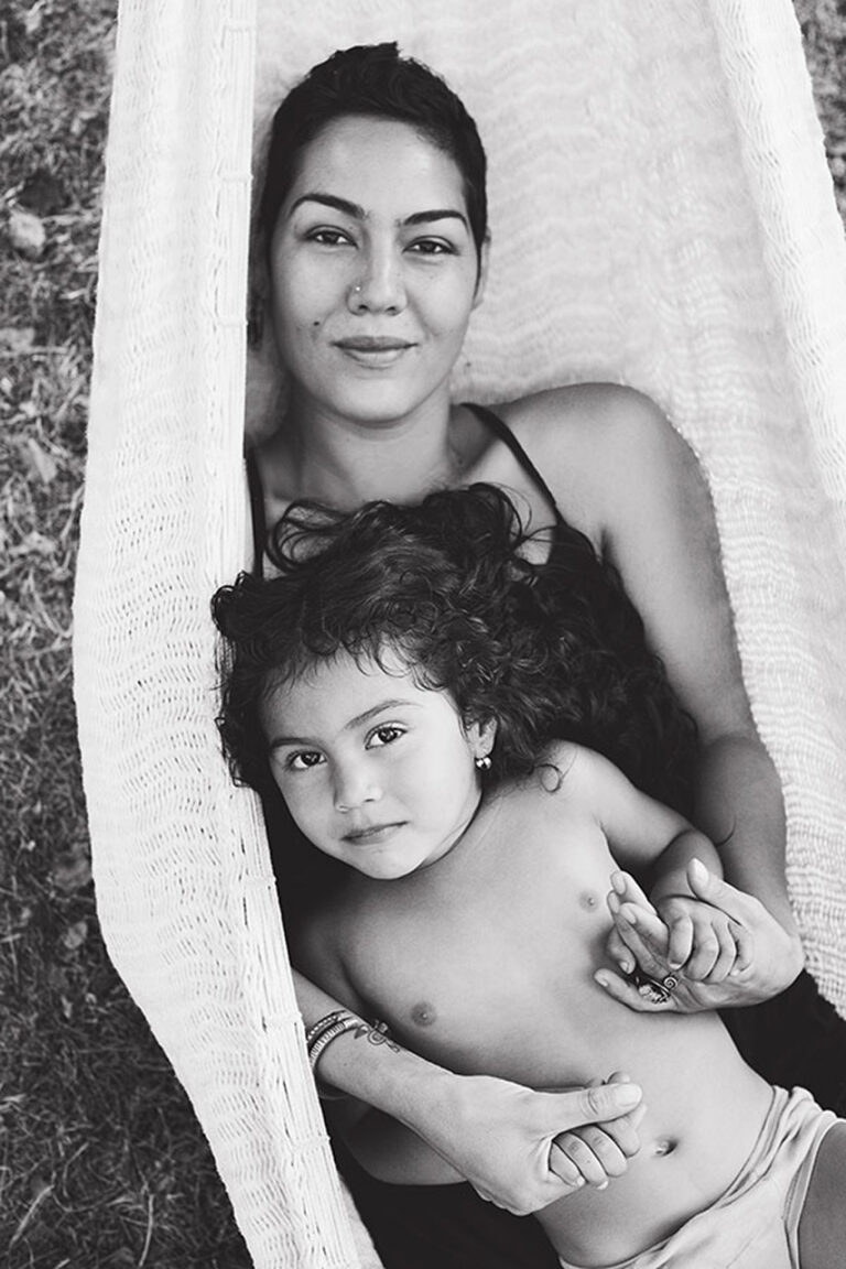 Mother and child relaxing in a hammock.